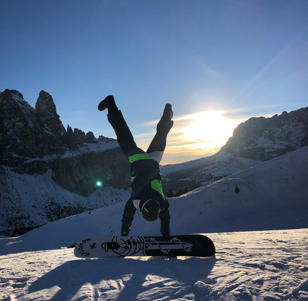 photo-of-person-doing-handstand-near-snowboard-1748597